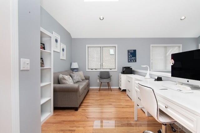 office space with lofted ceiling and light wood-type flooring