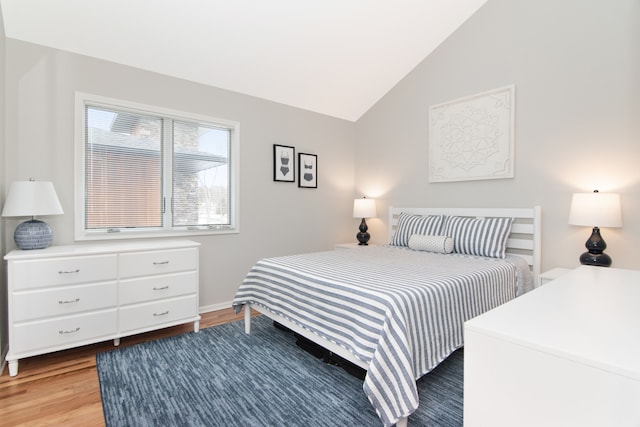 bedroom featuring vaulted ceiling and wood-type flooring