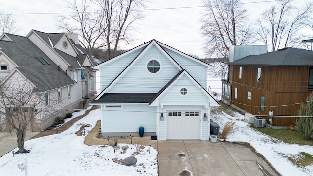 view of front facade with central AC unit and a garage