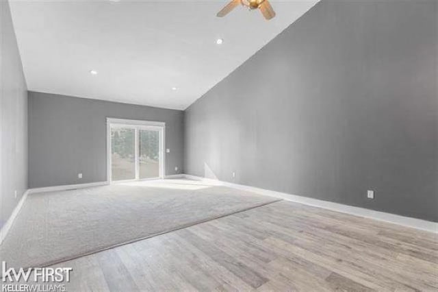 unfurnished living room featuring ceiling fan, light hardwood / wood-style flooring, and high vaulted ceiling