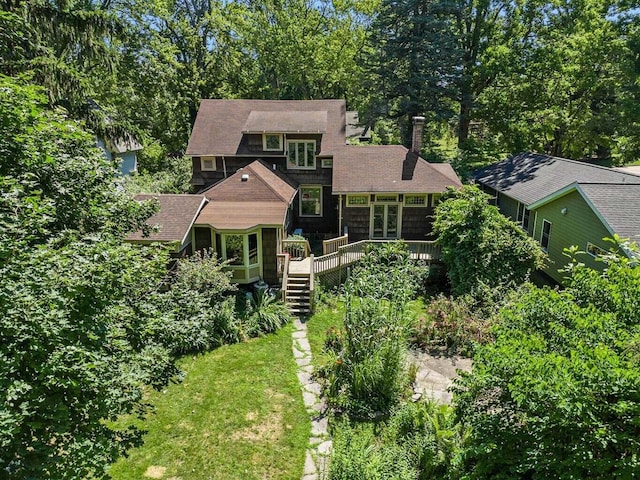 view of front of property with a wooden deck and a front lawn