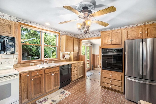 kitchen featuring ceiling fan, sink, and black appliances