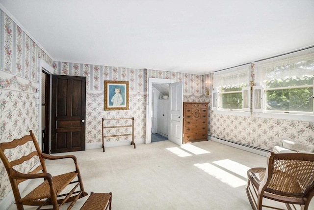 living area with light carpet and baseboard heating