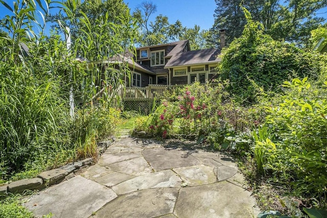 back of property featuring a wooden deck