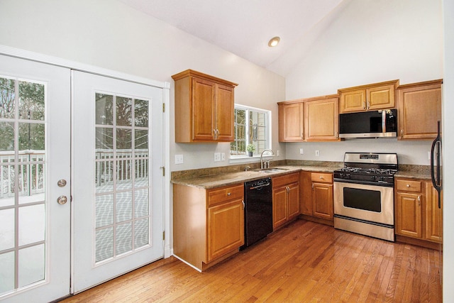 kitchen featuring a wealth of natural light, french doors, sink, stainless steel appliances, and light hardwood / wood-style flooring