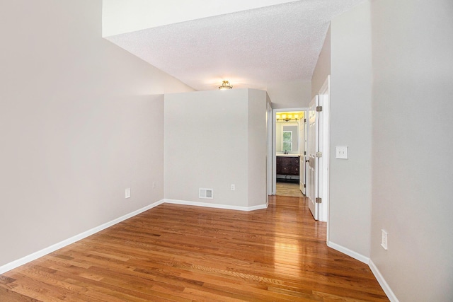 empty room featuring hardwood / wood-style flooring and a textured ceiling