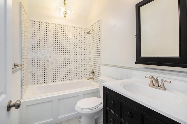 full bathroom with vanity, tiled shower / bath combo, and toilet