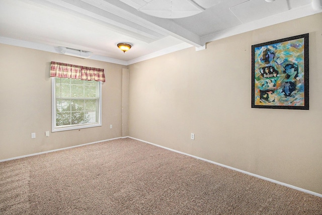 carpeted empty room with ornamental molding and beamed ceiling