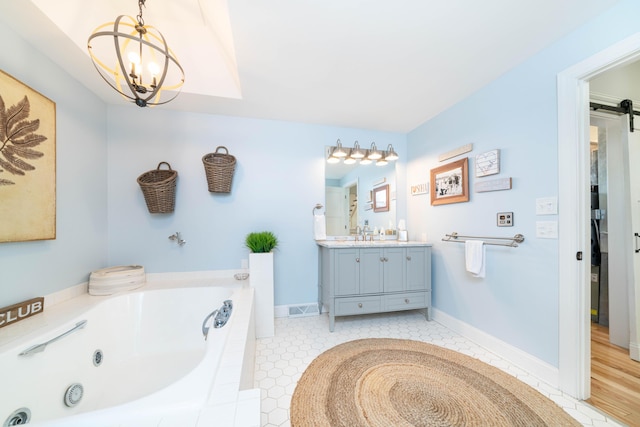 bathroom with a relaxing tiled tub, vanity, an inviting chandelier, and tile patterned flooring