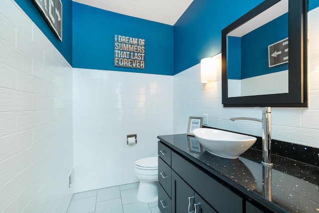 bathroom featuring vanity, toilet, and tile patterned floors