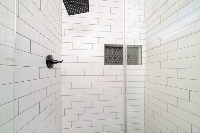 bathroom with tiled shower