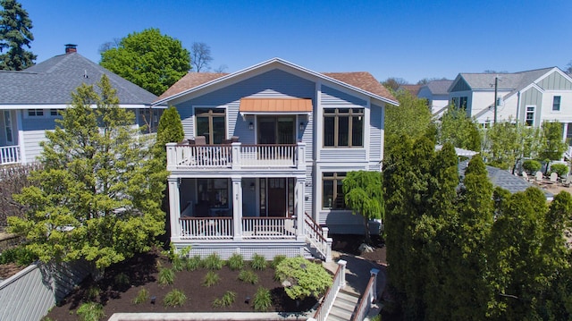 back of property with a balcony