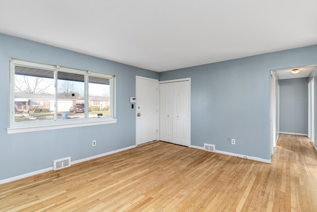 empty room with light hardwood / wood-style flooring