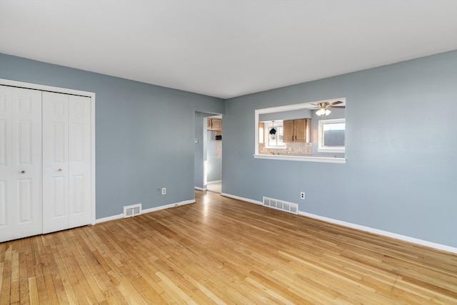 unfurnished bedroom with a closet and light wood-type flooring