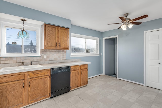 kitchen with pendant lighting, sink, dishwasher, ceiling fan, and tasteful backsplash