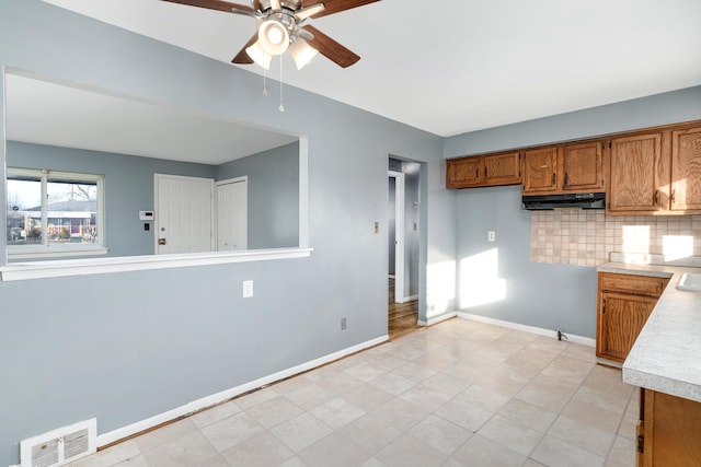 kitchen featuring tasteful backsplash and ceiling fan