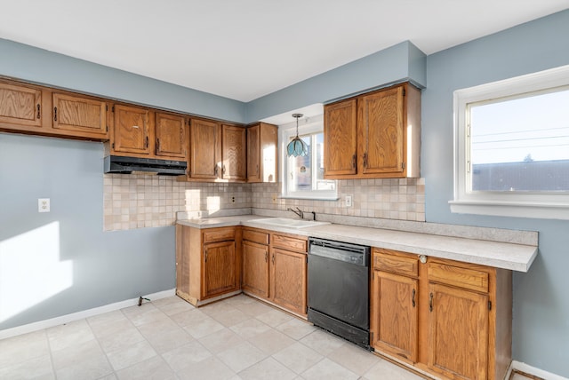 kitchen with hanging light fixtures, dishwasher, sink, and tasteful backsplash