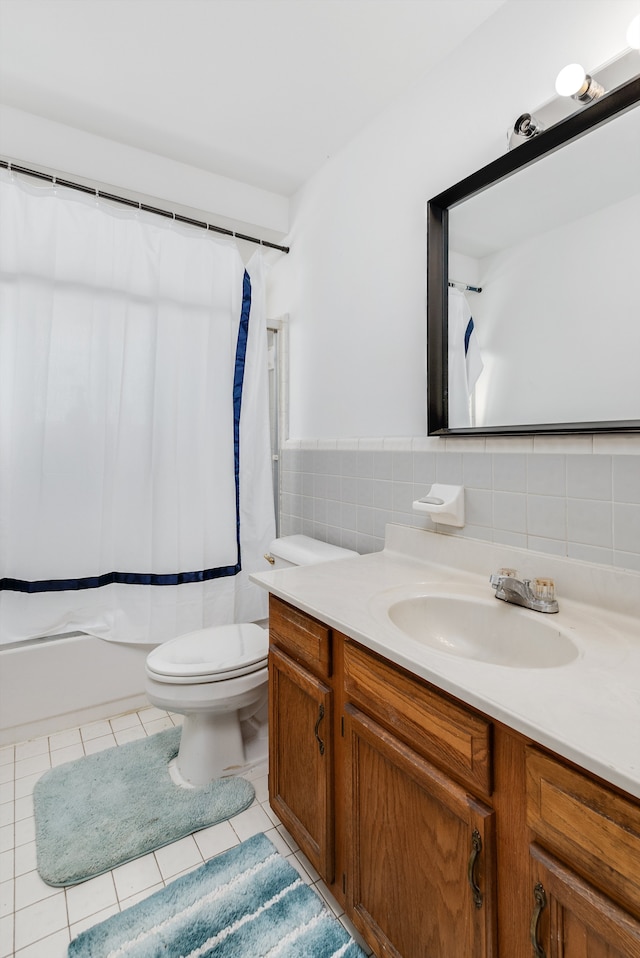 full bathroom with tile walls, tile patterned flooring, vanity, toilet, and shower / bath combo