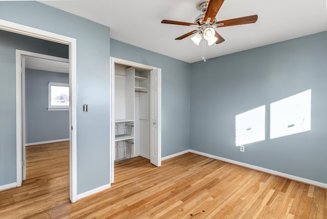 unfurnished bedroom featuring ceiling fan, a closet, and light hardwood / wood-style flooring