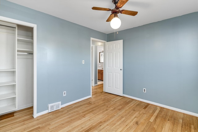 unfurnished bedroom featuring ceiling fan, a closet, and light hardwood / wood-style flooring