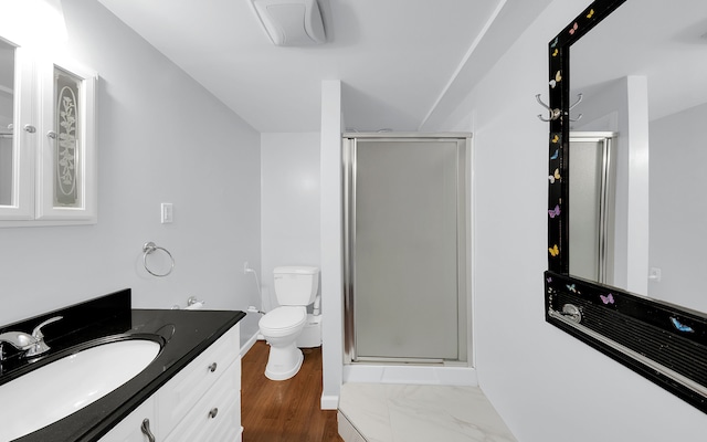 bathroom featuring baseboards, toilet, a shower stall, and vanity