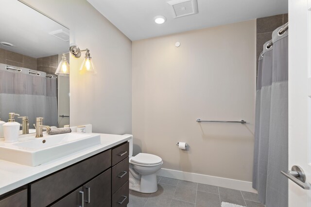 bathroom featuring vanity, toilet, walk in shower, and tile patterned floors