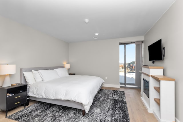 bedroom featuring light hardwood / wood-style flooring and access to outside