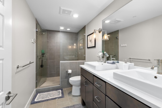 bathroom with toilet, tile patterned flooring, an enclosed shower, and vanity