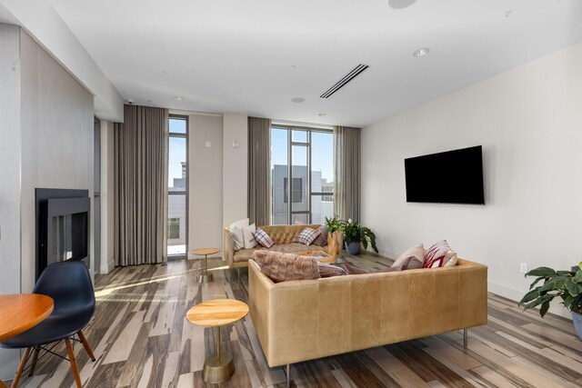 living room with hardwood / wood-style flooring and floor to ceiling windows