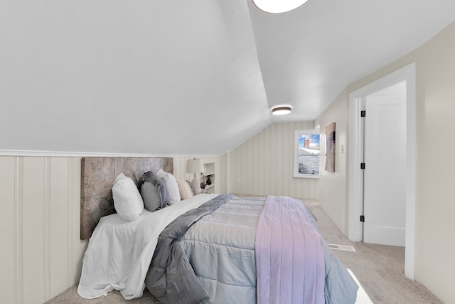 carpeted bedroom with lofted ceiling