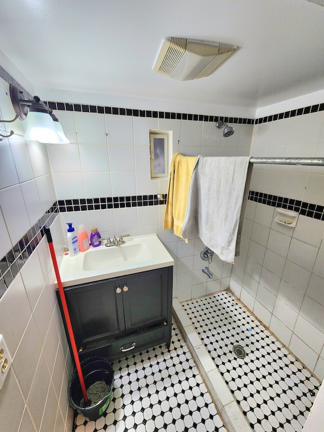 bathroom with tile walls and walk in shower