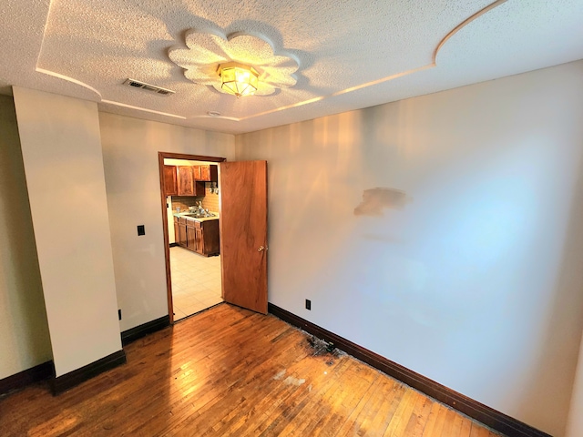 unfurnished room featuring hardwood / wood-style flooring