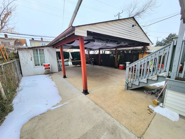 view of patio featuring a carport and an outdoor structure