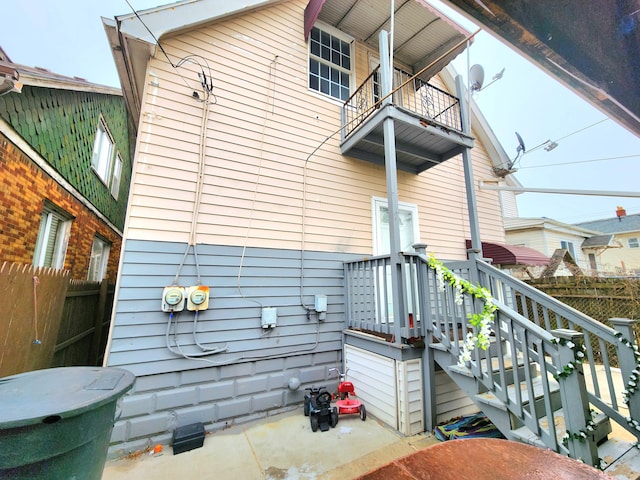 view of side of home with a balcony