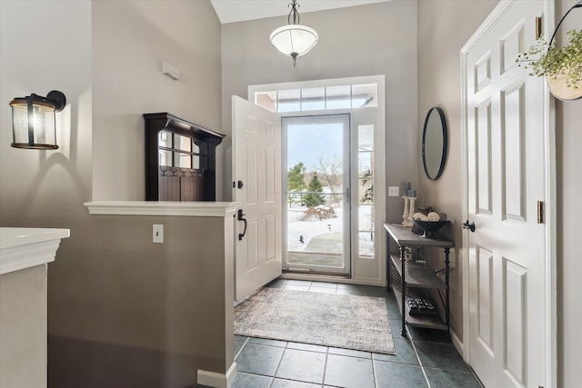 entrance foyer with dark tile patterned flooring