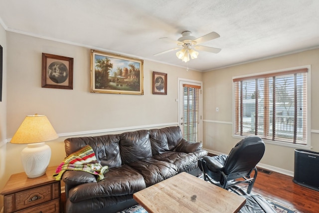 interior space featuring hardwood / wood-style floors, crown molding, and ceiling fan