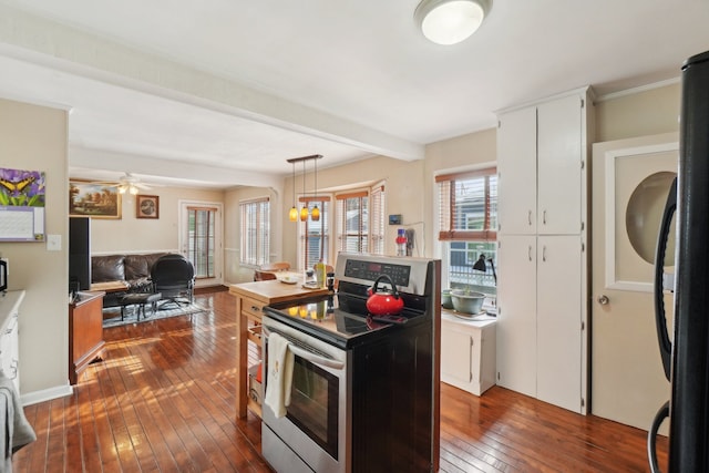 kitchen with black refrigerator, pendant lighting, white cabinets, electric range, and dark wood-type flooring