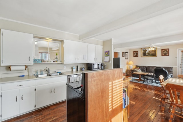 kitchen featuring sink, dark wood-type flooring, stainless steel appliances, and white cabinets