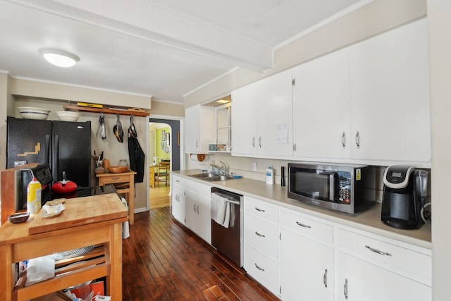 kitchen featuring appliances with stainless steel finishes, sink, white cabinets, dark hardwood / wood-style flooring, and crown molding