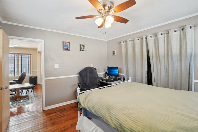 bedroom with crown molding, ceiling fan, and dark hardwood / wood-style flooring