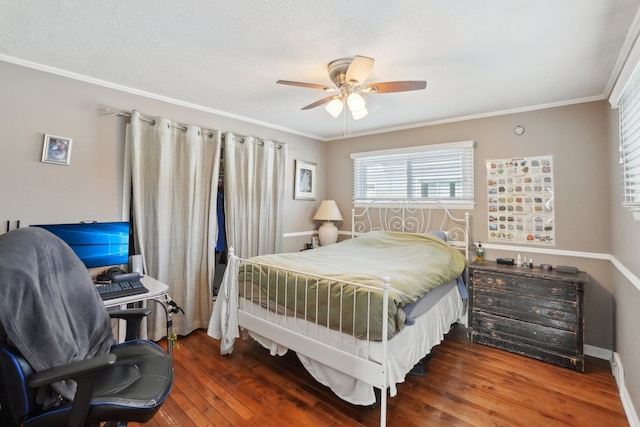 bedroom featuring crown molding, ceiling fan, dark hardwood / wood-style flooring, and a textured ceiling