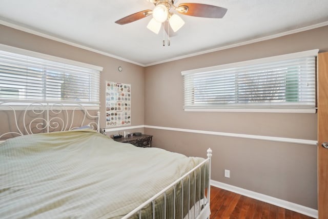 bedroom with multiple windows, crown molding, dark wood-type flooring, and ceiling fan