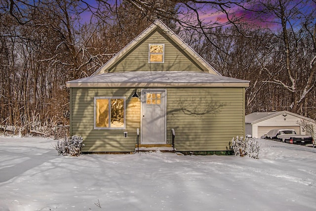 exterior space featuring a garage and an outbuilding