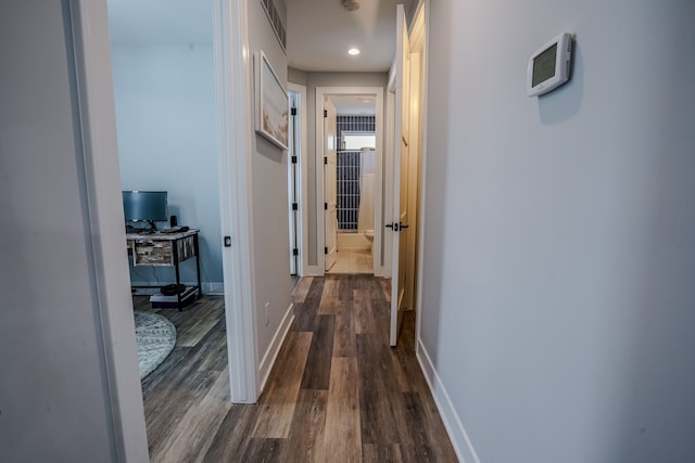 corridor with dark hardwood / wood-style flooring