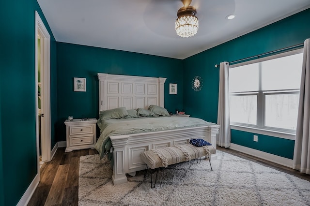 bedroom featuring dark wood-type flooring and a notable chandelier