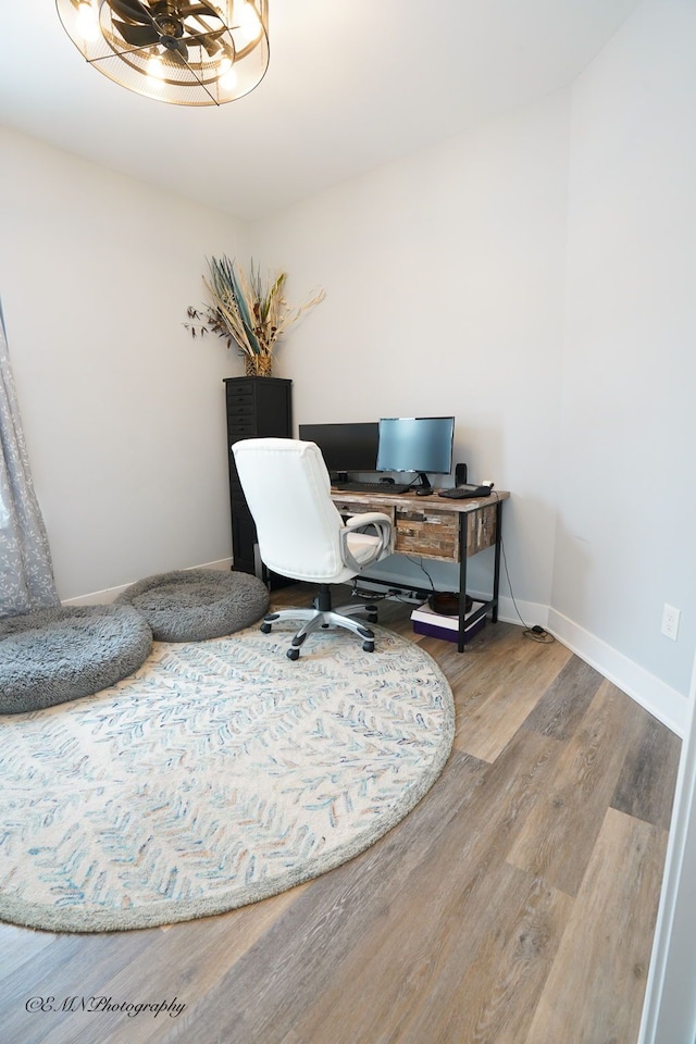 office area featuring hardwood / wood-style floors and an inviting chandelier