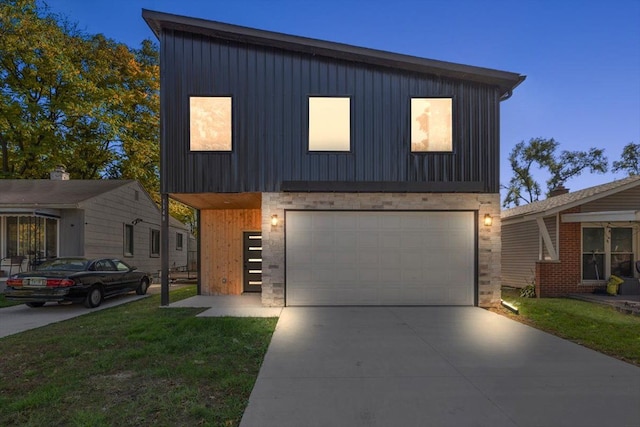 contemporary house with a yard and a garage