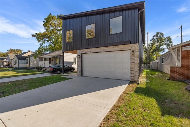 view of front of house with a garage and a front yard