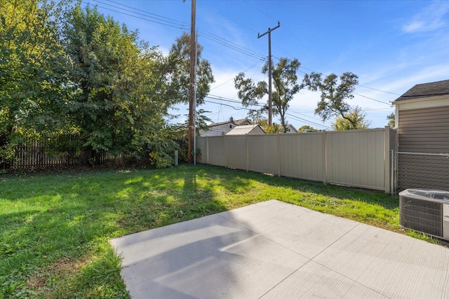 view of yard with central AC unit and a patio