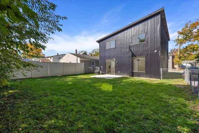 rear view of property with a patio area and a yard